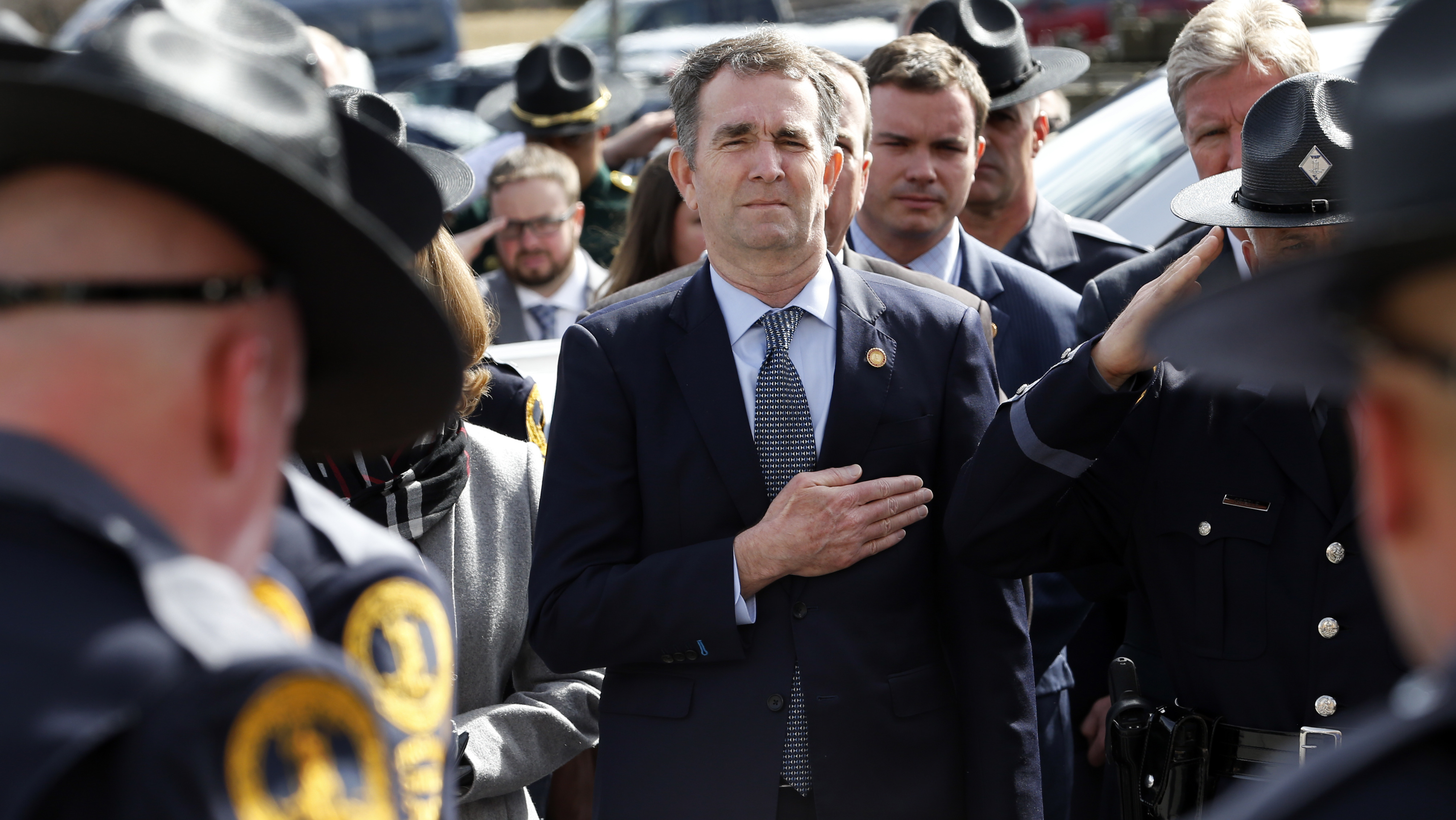 Virginia Gov. Ralph Northam places hand over his heart at a funeral for a state trooper Saturday in Chilhowie, Va., during one of his first public appearances since the blackface scandal broke.