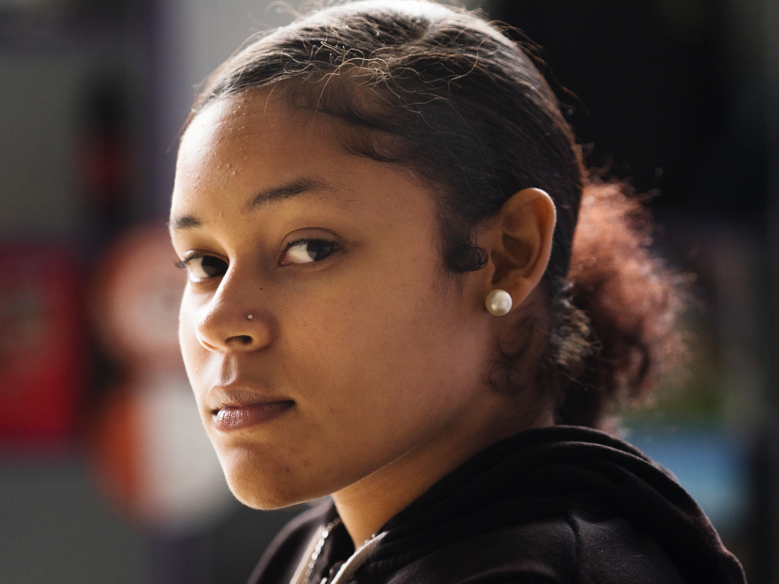 Ajahnay Cooper poses for a portrait at Castlemont High School in Oakland, Calif., where she is a student. The program Youth ALIVE! at Castlemont High School helps students who have been affected by gun violence and other traumas. (James Tensuan for NPR)