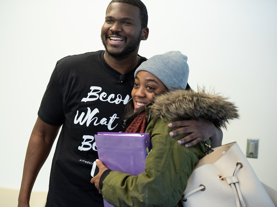 Marc Lavarin, an assistant minister at Alfred Street Baptist Church, hugs Howard University student Mya Thompson after she learns the church's members have paid the $2,500 she owed the university. (Alfred Street Baptist Church)