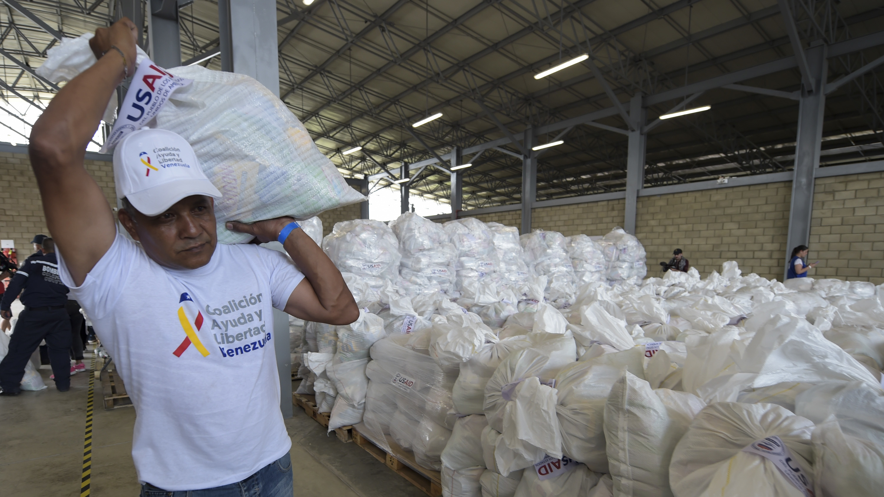 A volunteer carries a bag with U.S. humanitarian aid goods in Cúcuta, Colombia, along the border with Venezuela, on Feb. 8.