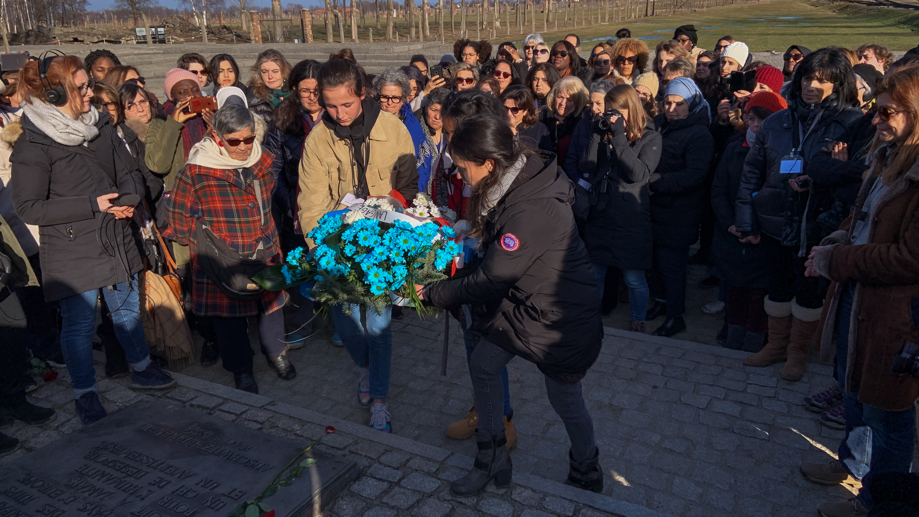 Members of a group of French women from diverse religious and ethnic backgrounds lay a wreath near the Auschwitz gas chambers earlier this month. After learning more about the horrors of the Holocaust, they hoped to bring greater understanding to their country riven by new acts of anti-Semitism.
