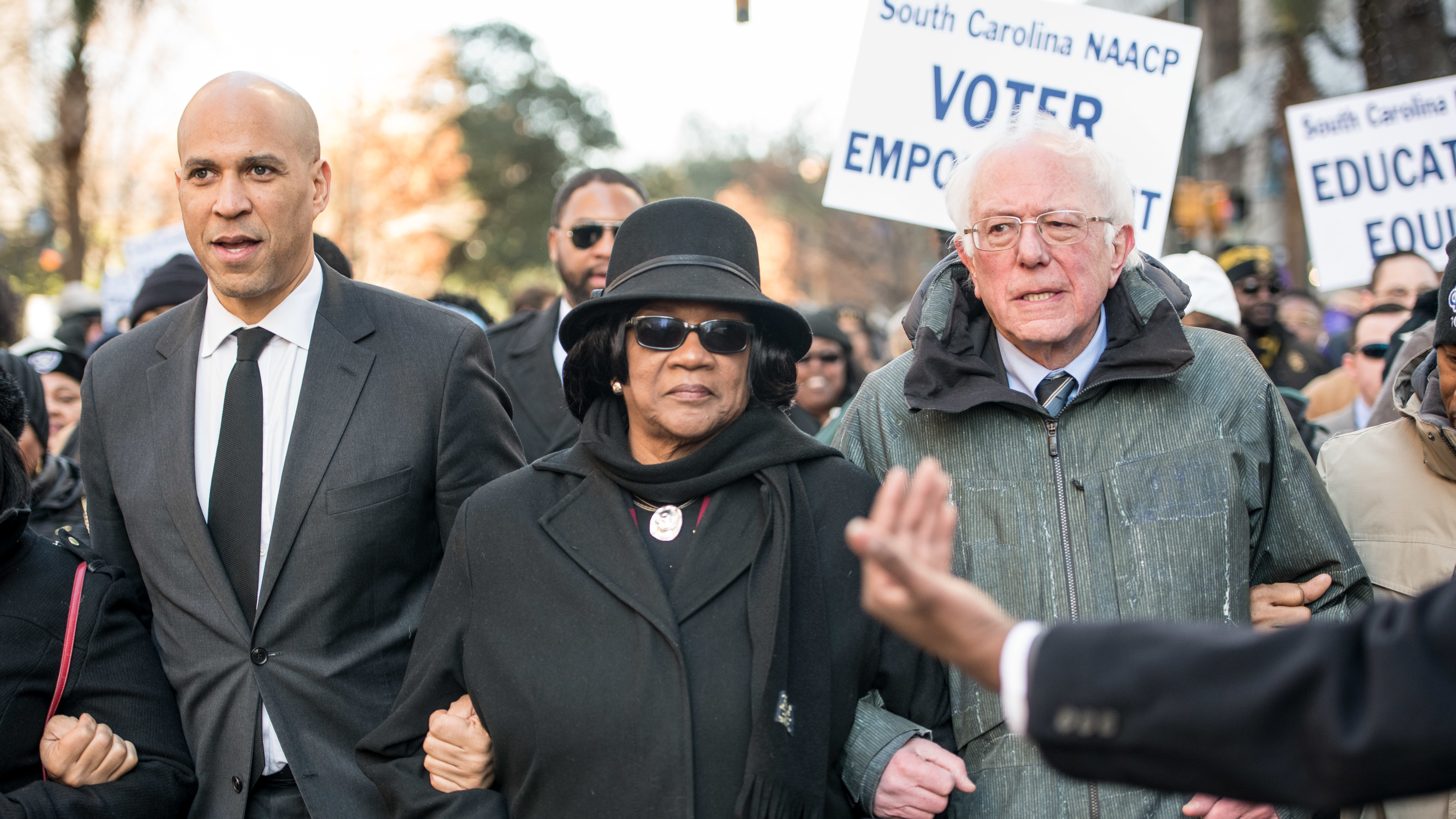 Sens. Cory Booker and Bernie Sanders, seen at a South Carolina NAACP march in January, are two of the 2020 Democratic presidential candidates pressed on the issue of reparations this week. (Getty Images)
