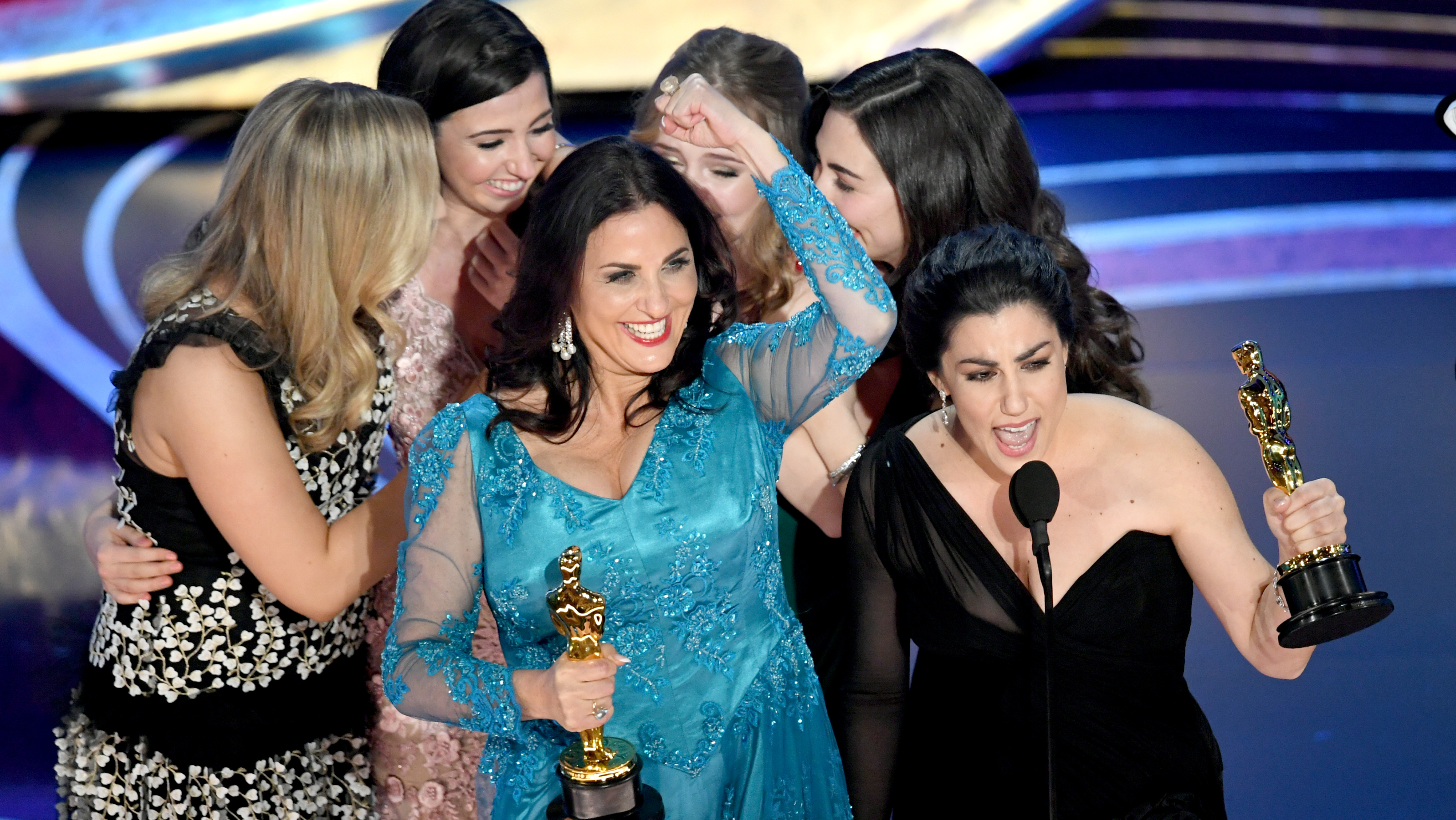 Producer Melissa Berton (center) and director Rayka Zehtabchi (right) accept an Oscar for their documentary 