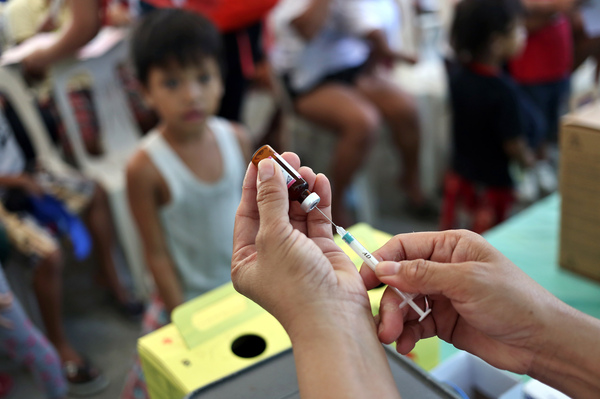 A measles vaccination campaign in Manila, Philippines, this year. The measles vaccine is believed to confer an additional benefit beyond immunity to the measles virus. Vaccinations against other diseases — polio, tuberculosis, typhoid — may also confer an unintended protection.