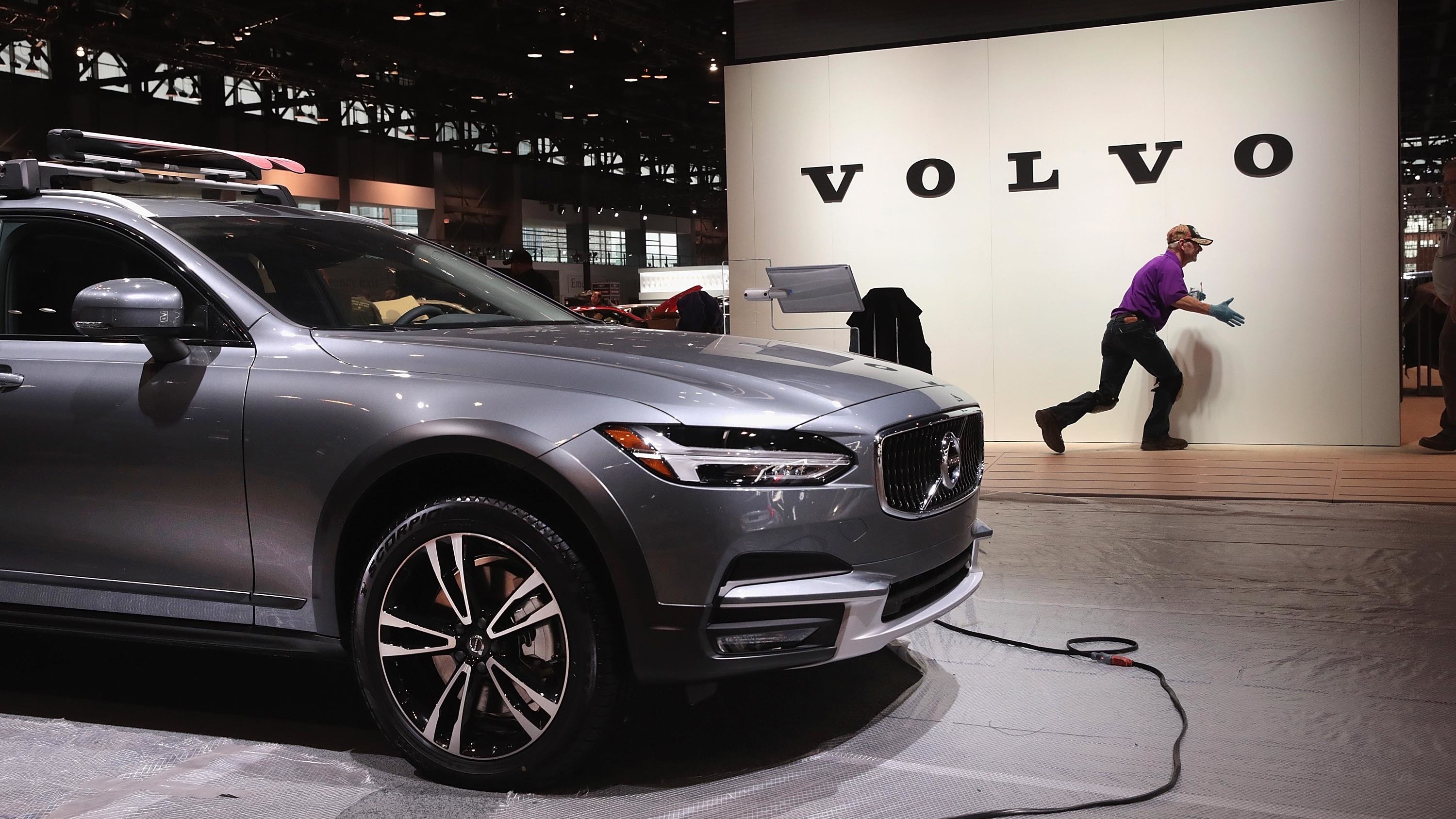 Volvo said it will limit all its new cars to a top speed of about 112 mph, starting in 2020. Here, workers on Feb. 6 prepare the Volvo display before the opening of the Chicago Auto Show. (Getty Images)