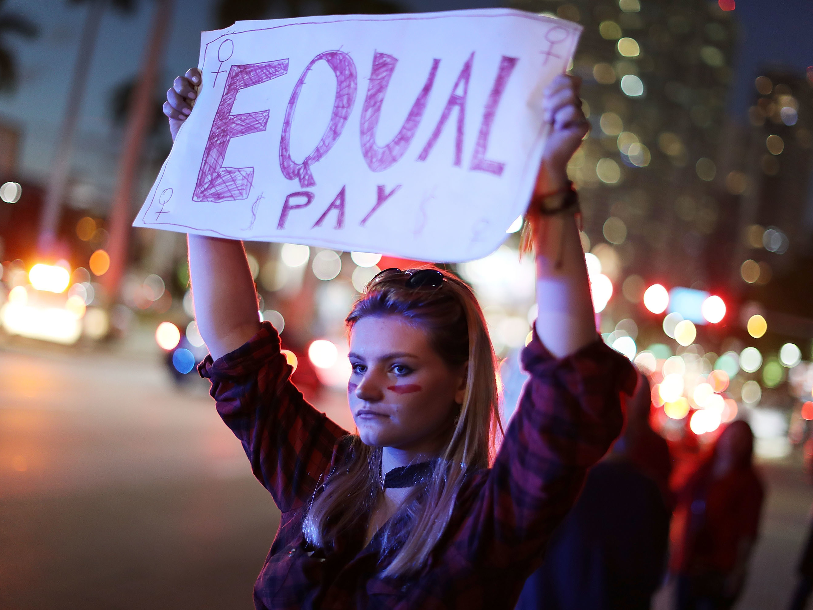 Clarissa Horsfall joins with others during &quot;A Day Without A Woman&quot; demonstration on March 8, 2017, in Miami. Employment attorneys say they've seen a spike in pay-disparity cases. (Getty Images)
