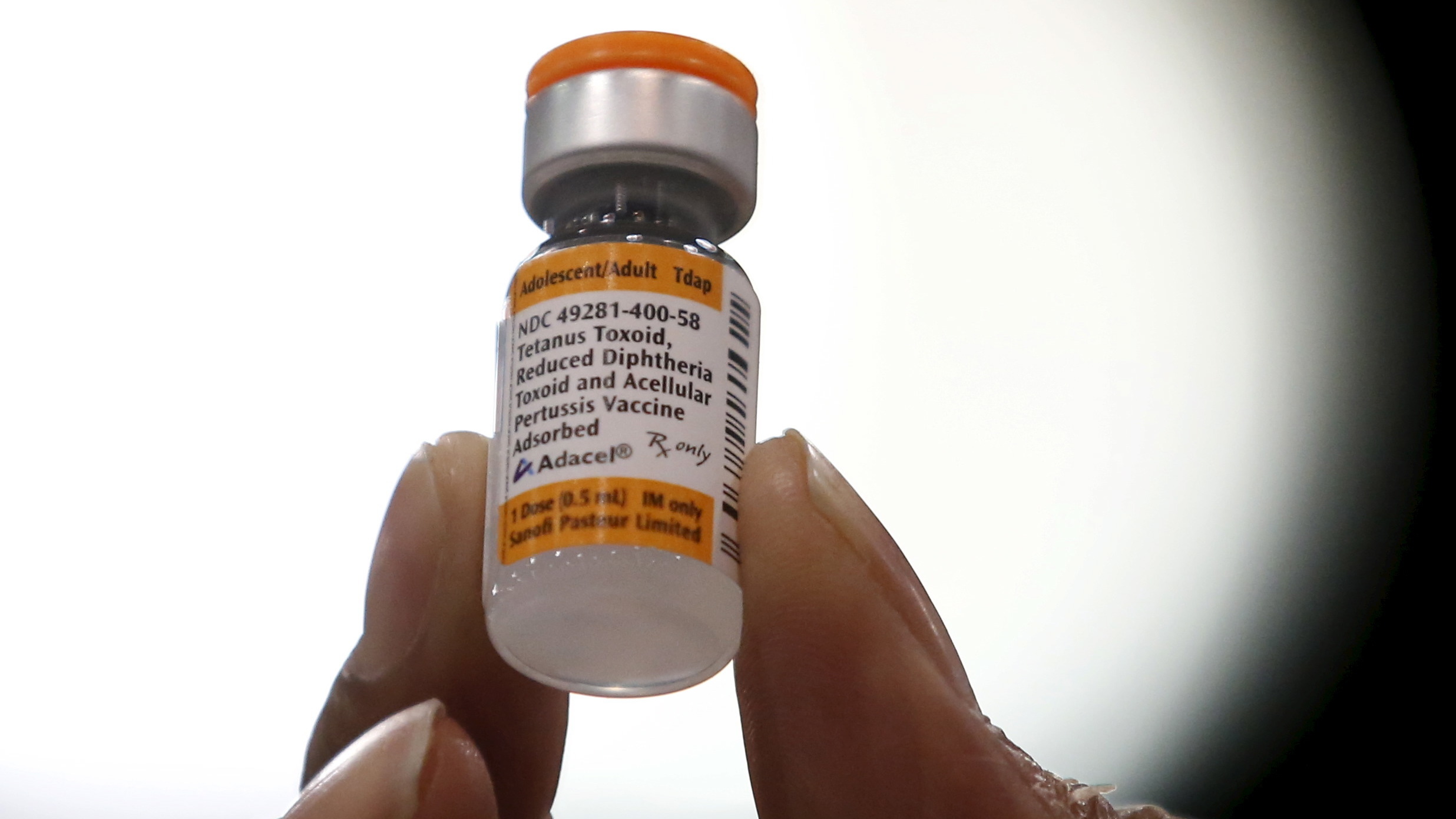 A nurse holds a tetanus, diphtheria and whooping cough vaccine in 2016. On Friday, a Centers for Disease Control and Prevention report discussed an unvaccinated child in Oregon who spent weeks at a hospital in 2017 after getting a tetanus infection.