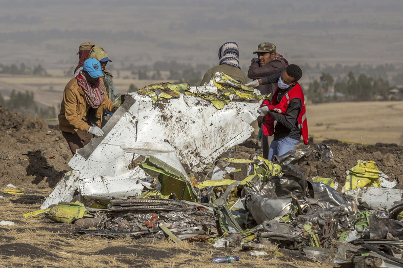 Responders at the scene of an Ethiopian Airlines flight crash. Countries around the world have grounded their Boeing 737 Max jets and there is growing political pressure on the Federal Aviation Administration to do the same. (Mulugeta Ayene/AP)