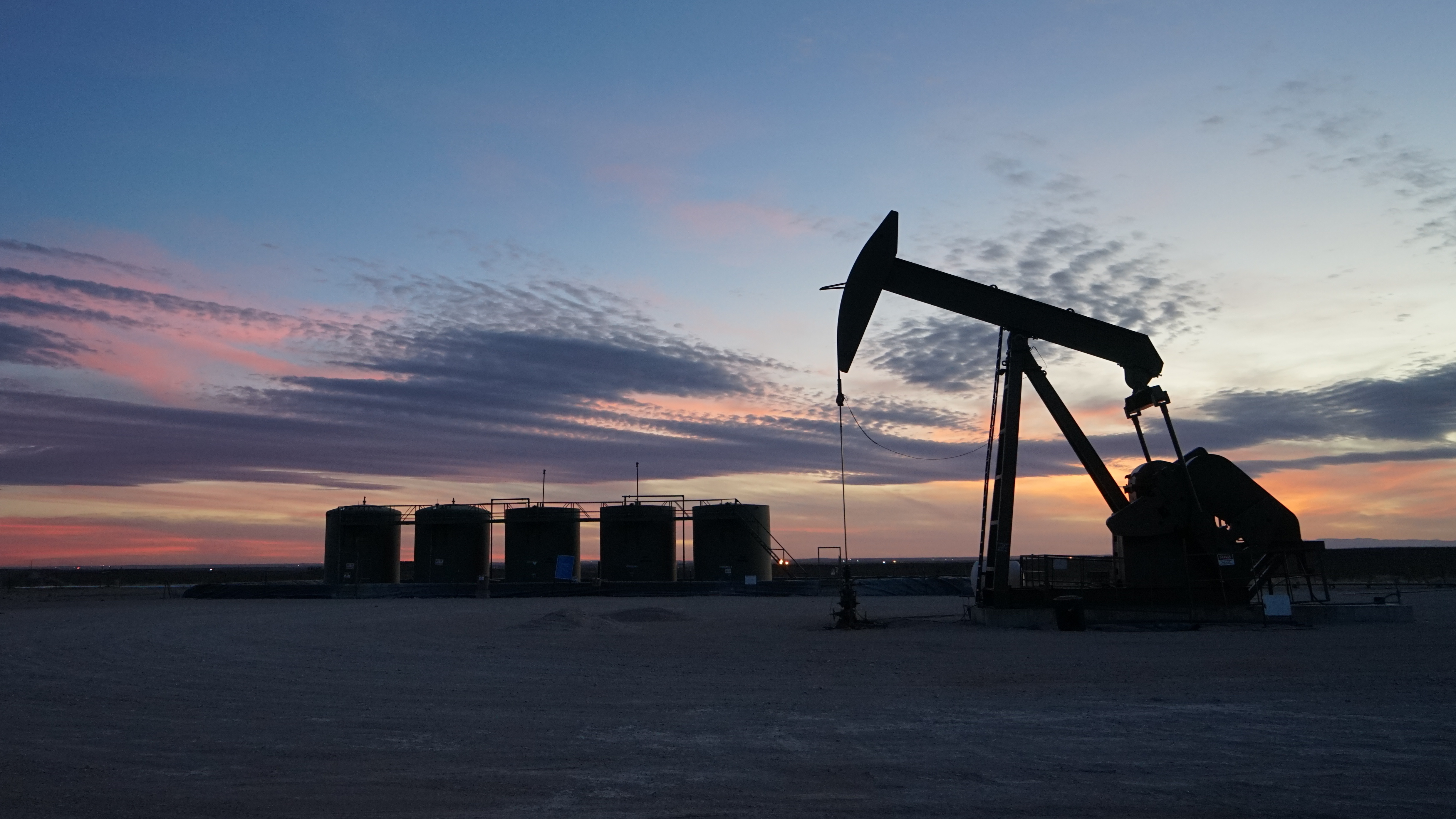 Pumpjacks like this one dot the desert of southeast New Mexico, as oil and gas companies rush to develop one of the largest oil reserves in the world. (NPR)