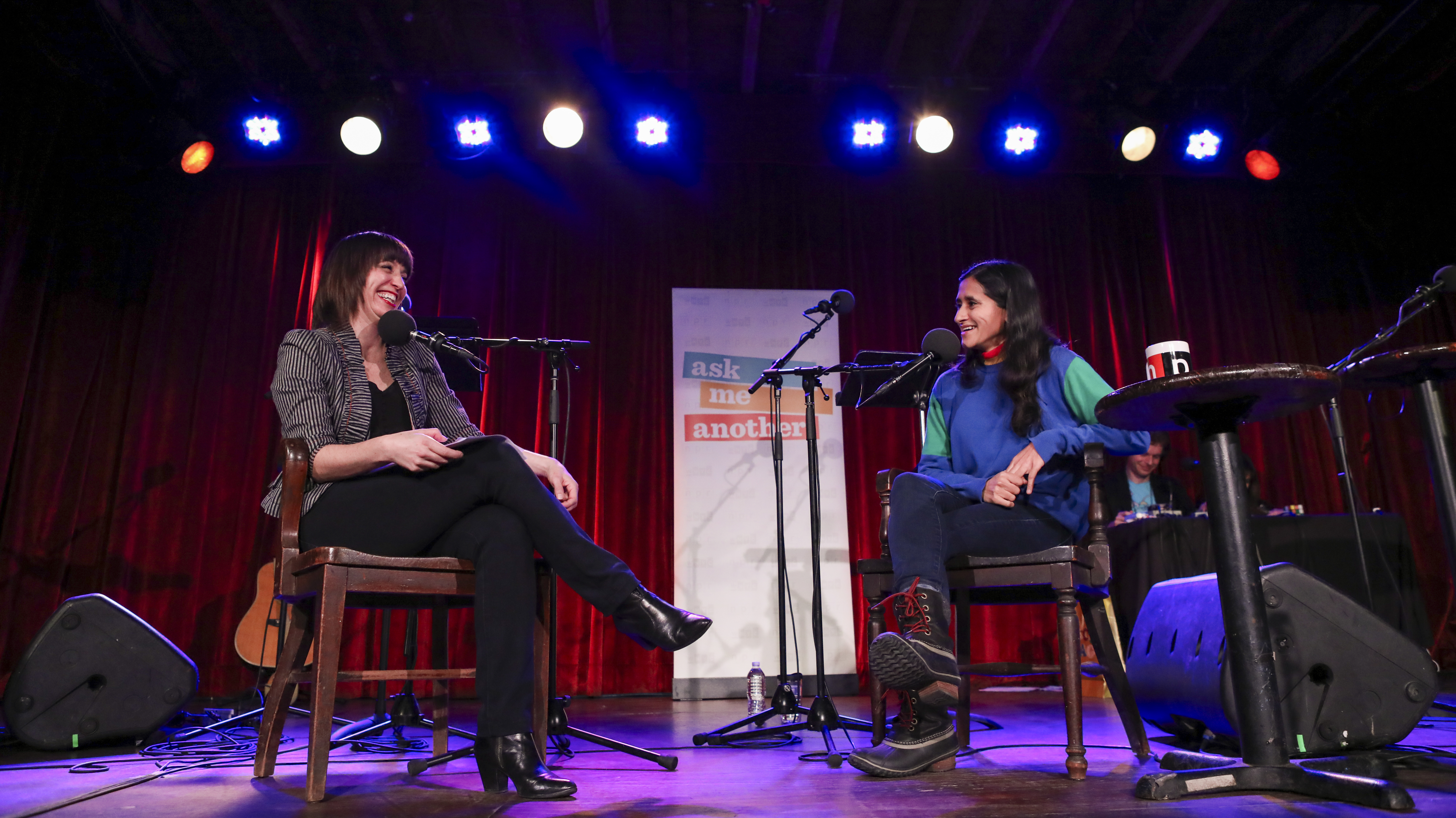 Host Ophira Eisenberg chats with comedian Aparna Nancherla on Ask Me Another at the Bell House in Brooklyn, New York.