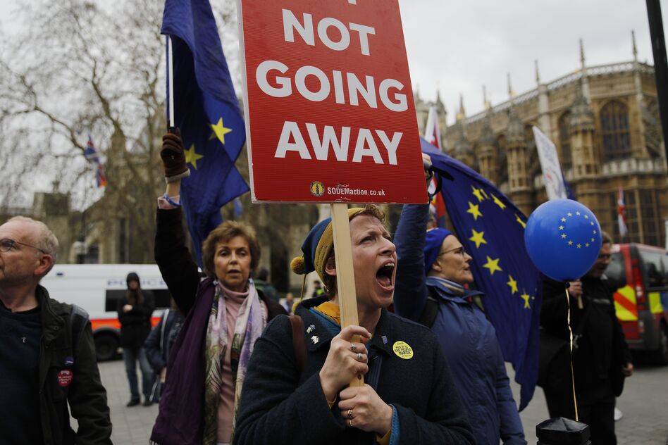 Demonstrators carry EU flags and shout slogans outside the Houses of Parliament in central London on March 21. (Tolga Akmen/AFP/Getty Images)