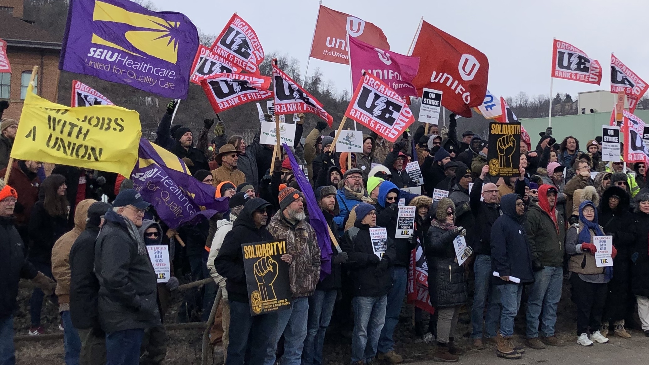 Union members and activists protest over contract negotiations with Wabtec Corporation in Wilmerding, Pa., on March 6. Many are workers from one of the company's facilities in Erie County, which flipped from voting for Barack Obama to Donald Trump in 2016. (NPR)