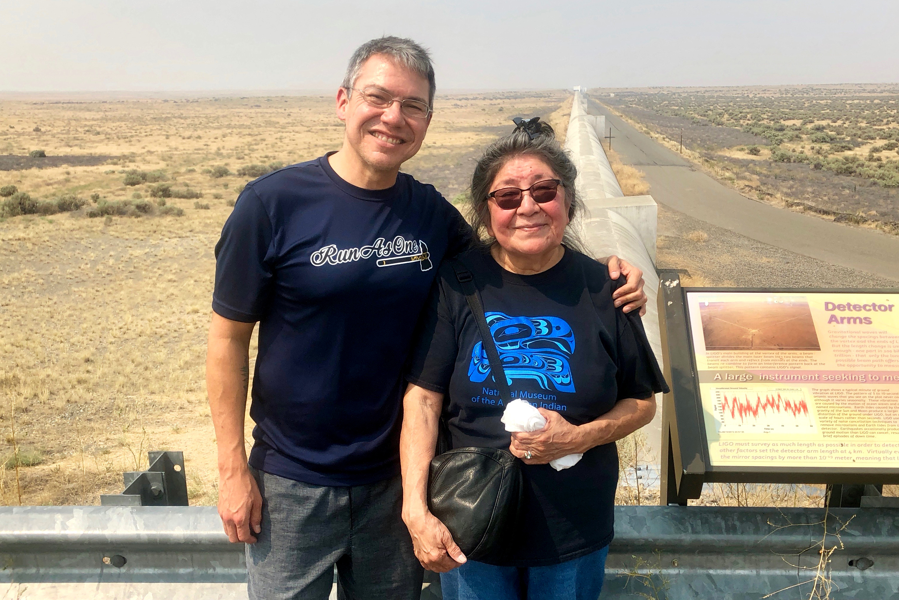Scientist Corey Gray and his mother, Sharon Yellowfly, are pictured at one of the two massive detectors that make up the Laser Interferometer Gravitational-Wave Observatory. One facility, where Gray works, is in Washington state, and the other is in Louisiana.
