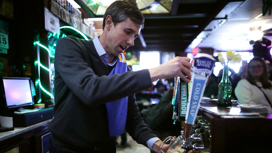 Democratic presidential candidate Beto O'Rourke pours a beer for a customer at Yock's Landing on March 15 in Mount Vernon, Iowa. (Chip Somodevilla/Getty Images)