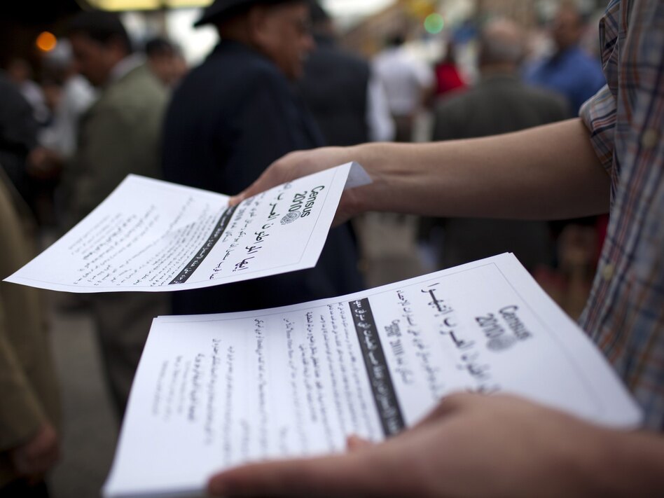 Worshippers exiting a mosque in the Bay Ridge neighborhood of Brooklyn, N.Y., are handed fliers encouraging participation in the 2010 census. (Robert Nickelsberg/Getty Images)