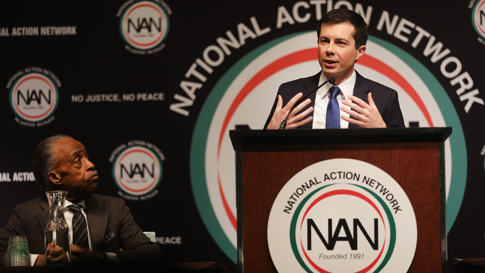 With the Rev. Al Sharpton looking on, Democratic presidential hopeful South Bend, Ind., Mayor Pete Buttigieg speaks at the National Action Network's annual convention Friday in New York City. (Spencer Platt/Getty Images)