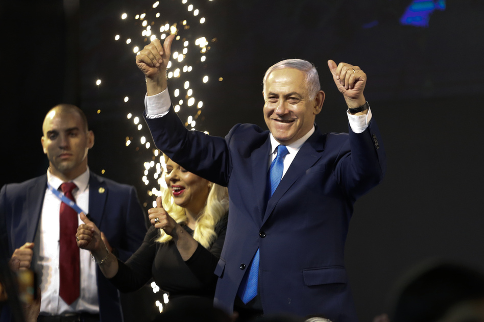Israel's Prime Minister Benjamin Netanyahu waves to his supporters in Tel Aviv after polls for Israel's general elections closed. (Ariel Schalit/AP)