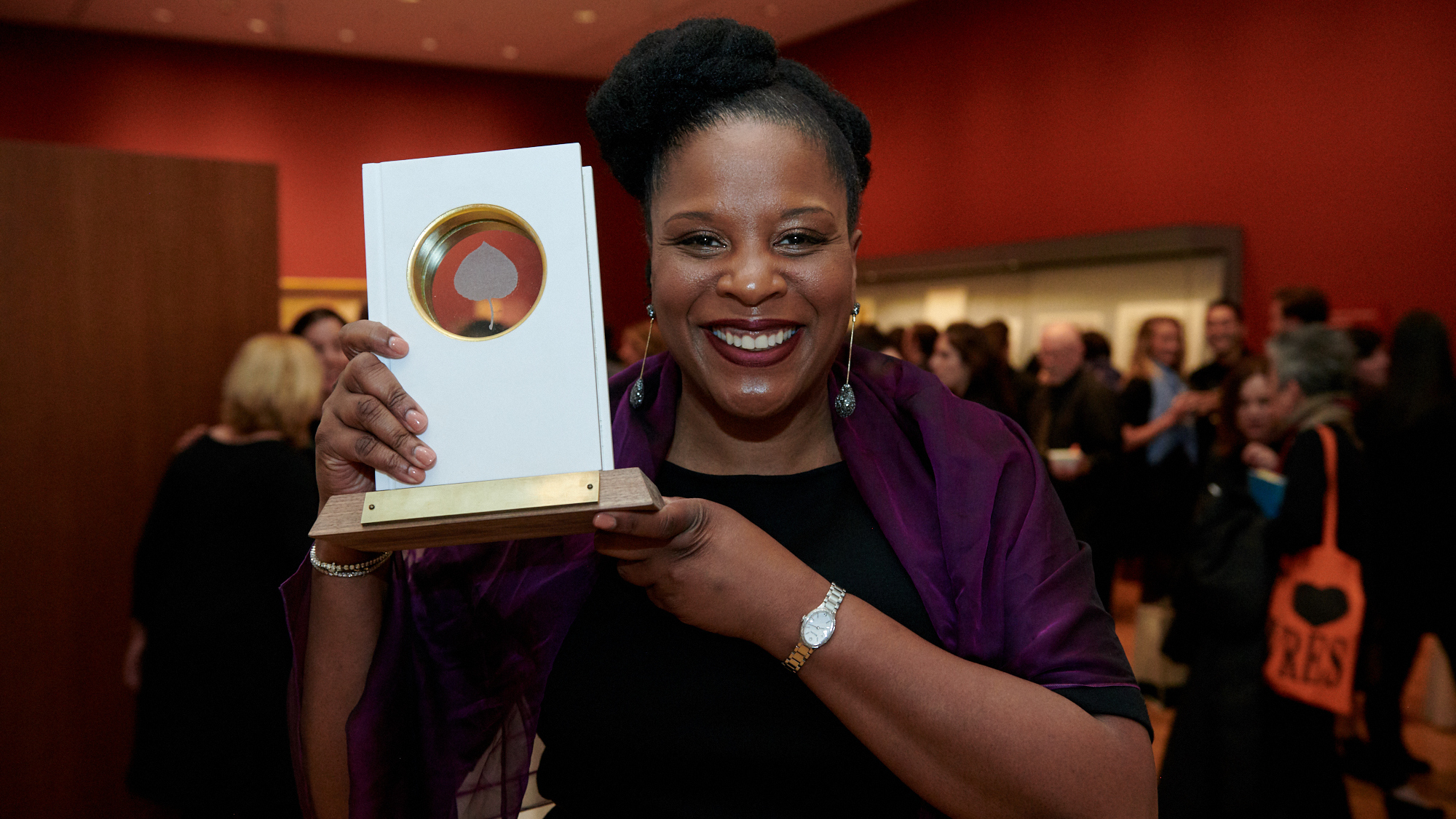 Tayari Jones holds up her Aspen Words Literary Prize, which she won Thursday in New York City for her novel An American Marriage.