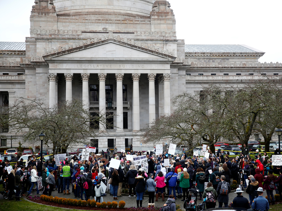 The Washington state Senate passed a bill on Wednesday that would remove the personal belief exemption from the required vaccinations for measles, mumps and rubella. Here, people protest the related house bill outside Washington's Legislative Building in Olympia in February. (Lindsey Wasson/Reuters)