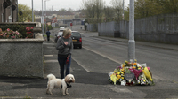 A woman stops to pay her respects Saturday at the scene where 29-year-old journalist Lyra McKee was fatally shot in Londonderry, Northern Ireland.