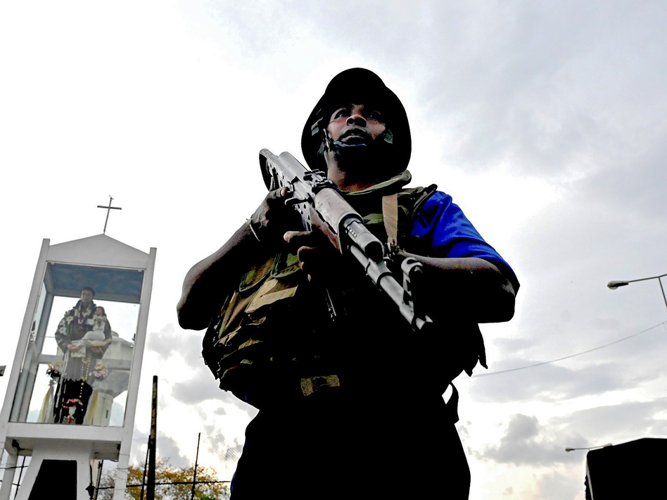 A Sri Lankan soldier stands guard near the site of a car explosion after police tried to defuse a bomb near St. Anthony's Shrine in Colombo on Monday, the day after a series of bomb blasts targeting churches and luxury hotels in Sri Lanka. (Jewel Samad/AFP/Getty Images)