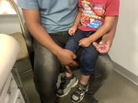 Sergio, a Guatemalan migrant, recently visited a mobile medical van with his 2-year-old son, Dylan. Sergio thinks his son became sick in a holding facility, where they spent two days.