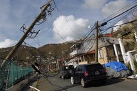 Damaged power lines hang over a street following Hurricane Irma hit in Charlotte Amalie, St. Thomas, U.S. Virgin Islands on Sept. 10, 2017. The storm ravaged such lush resort islands as St. Martin, St. Barts, St. Thomas, Barbuda and Anguilla.
