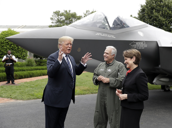 President Trump talks with Lockheed Martin President and CEO Marillyn Hewson and director and chief test pilot Alan Norman in front of an F-35 at the White House in July 2018.