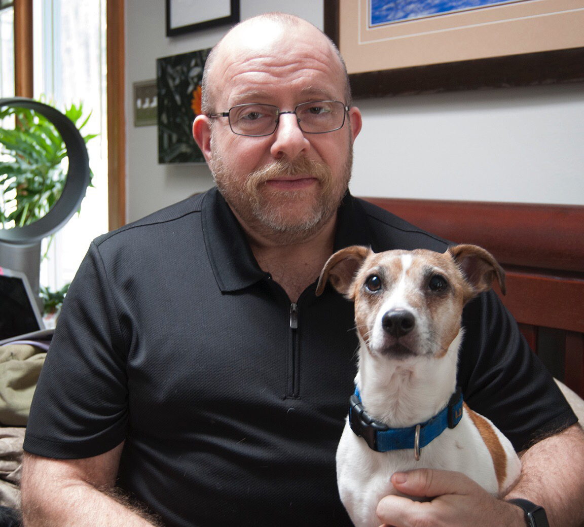 Phil Gutis with his dog, Abe, who died last year. Gutis, who has Alzheimer's, hoped an experimental drug could help preserve his memories. (Courtesy of Timothy Weaver)