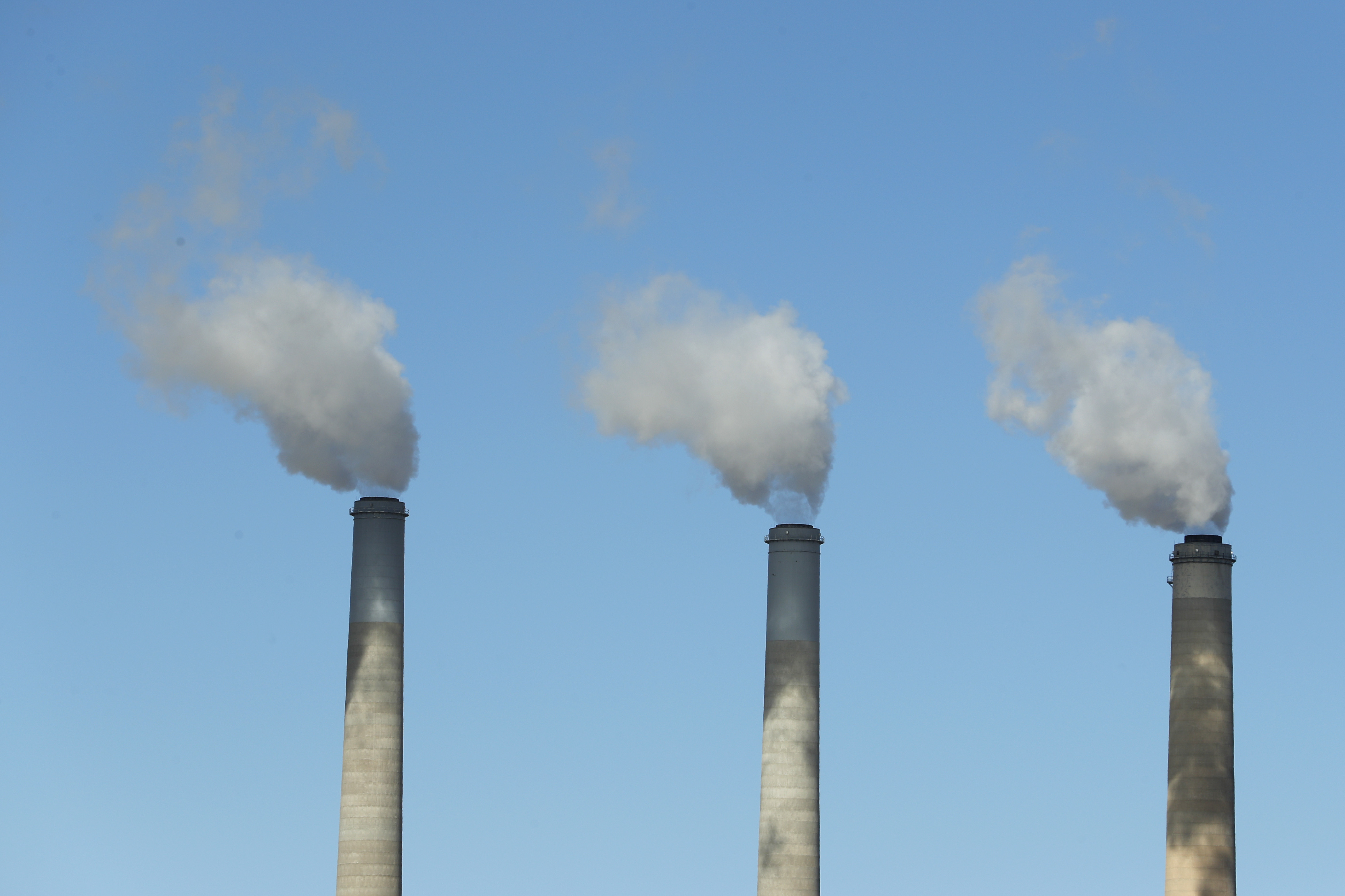 Emissions rise from three large smokestacks at a coal-fired power plant in Castle Dale, Utah, in 2017. Democratic presidential candidates are releasing plans to reduce U.S. emissions in order to head off the most dangerous consequences of global warming. (Getty Images)