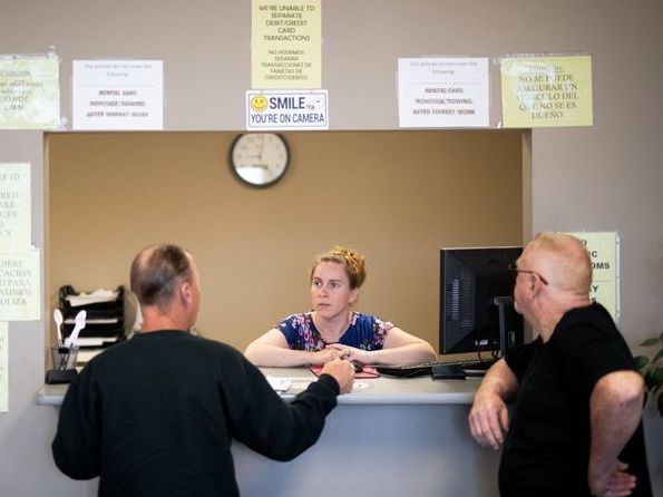 Clarisa Corber at work at a Topeka, Kan., insurance agency. Corber and her husband — who have three kids, a health plan and $15,000 in medical debt — were profiled in a recent <em>Los Angeles Times</em> <a href=&quot;https://www.latimes.com/politics/la-na-pol-health-insurance-medical-debt-20190502-story.html&quot;>investigation into the effects of high-deductible health plans</a>. (Los Angeles Times)