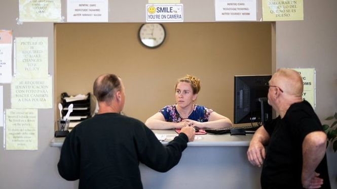 Clarisa Corber at work at a Topeka, Kan., insurance agency. Corber and her husband — who have three kids, a health plan and $15,000 in medical debt — were profiled in a recent Los Angeles Times investigation into the effects of high-deductible health plans.