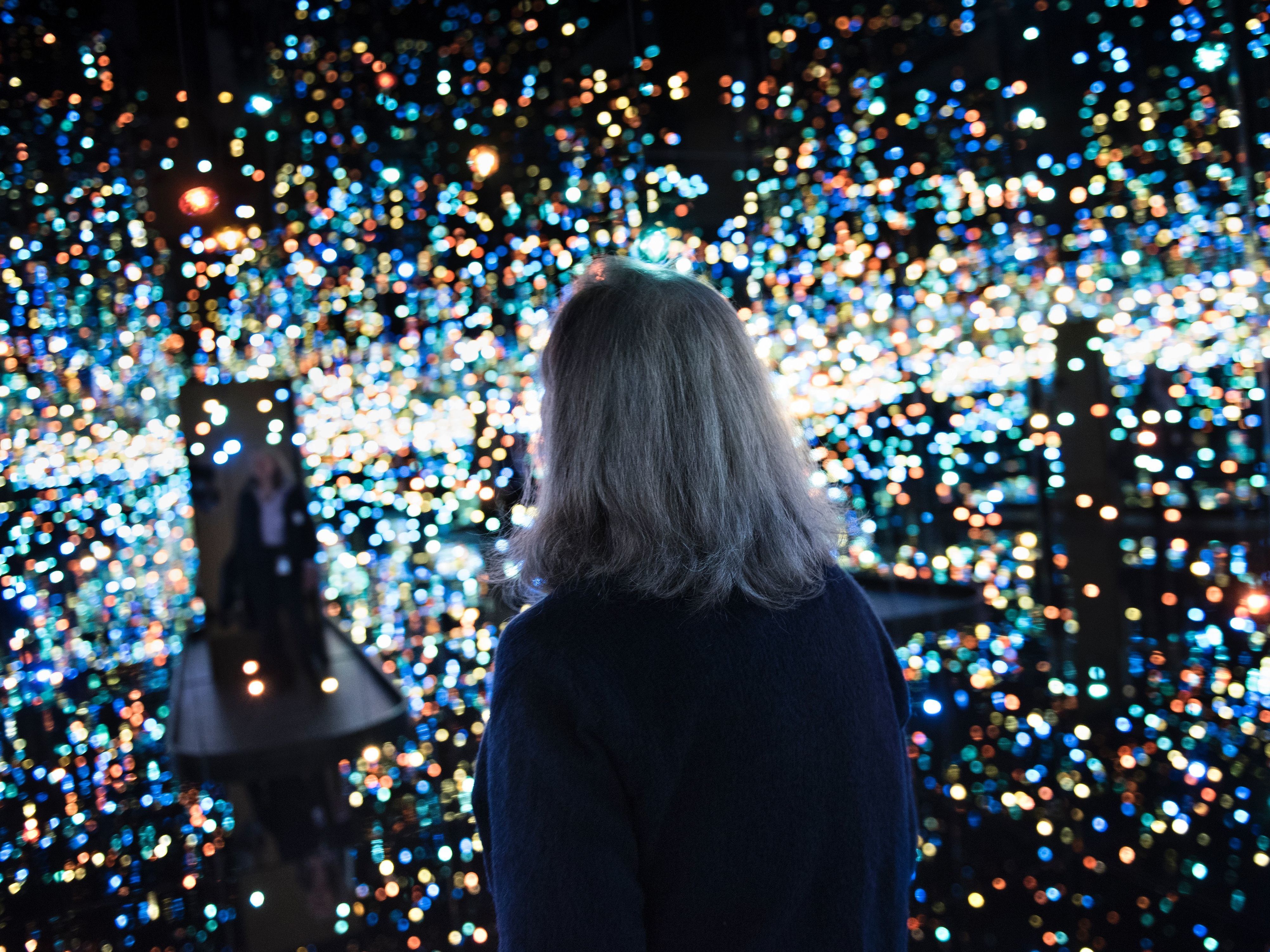 A woman enters the <em>The Souls of Millions of Light Years Away</em> room during a preview of the Yayoi Kusama's<em> Infinity Mirrors</em> exhibit. (AFP/Getty Images)