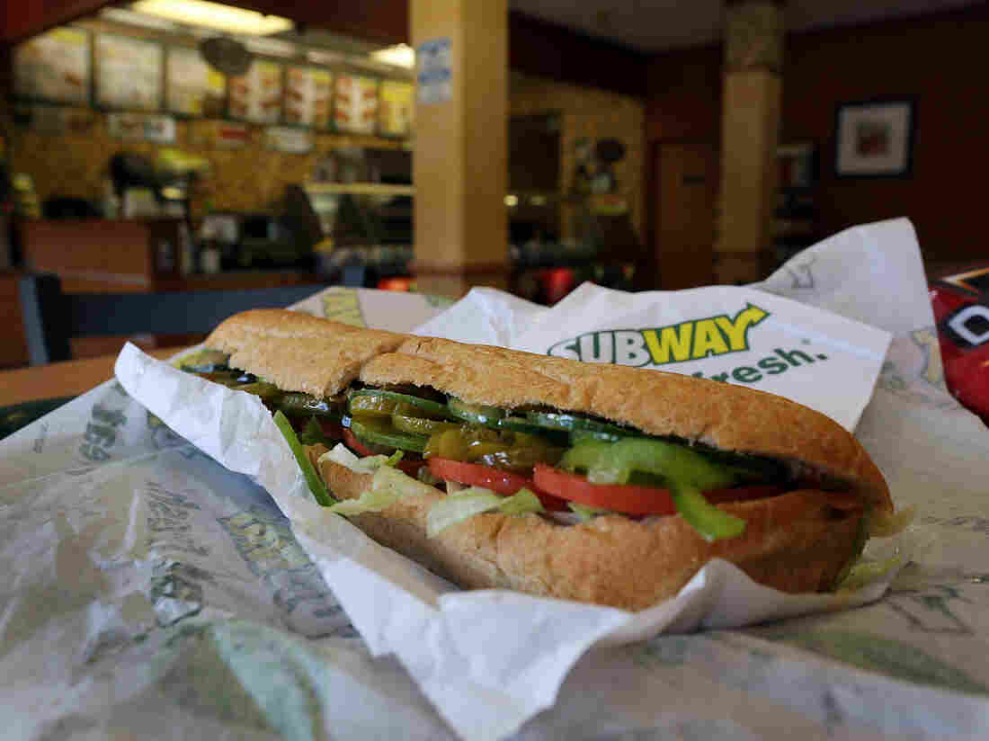 A Subway sandwich is seen in a restaurant as the company announced a settlement over a class-action lawsuit that alleged that Subway engaged in deceptive marketing for its 6-inch and 12-inch sandwiches and served customers less food than they were paying for on October 21, 2015 in Miami, Florida. (Photo by Joe Raedle/Getty Images)