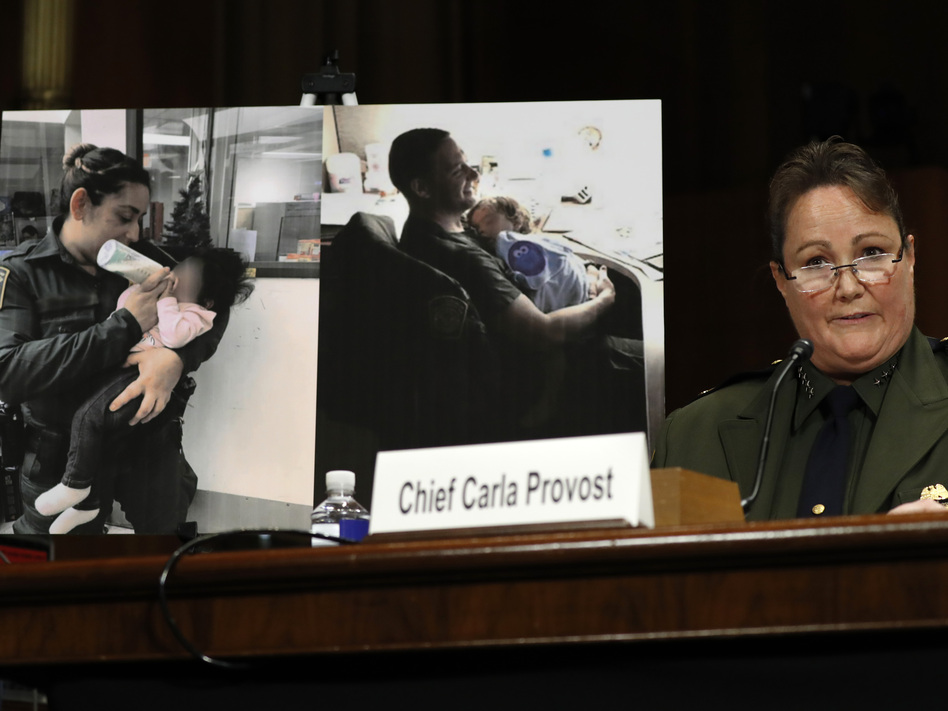 U.S. Border Patrol Chief Carla Provost testifies by a photo of agents with children during a Senate Judiciary Border Security and Immigration Subcommittee hearing. (Jacquelyn Martin/AP)