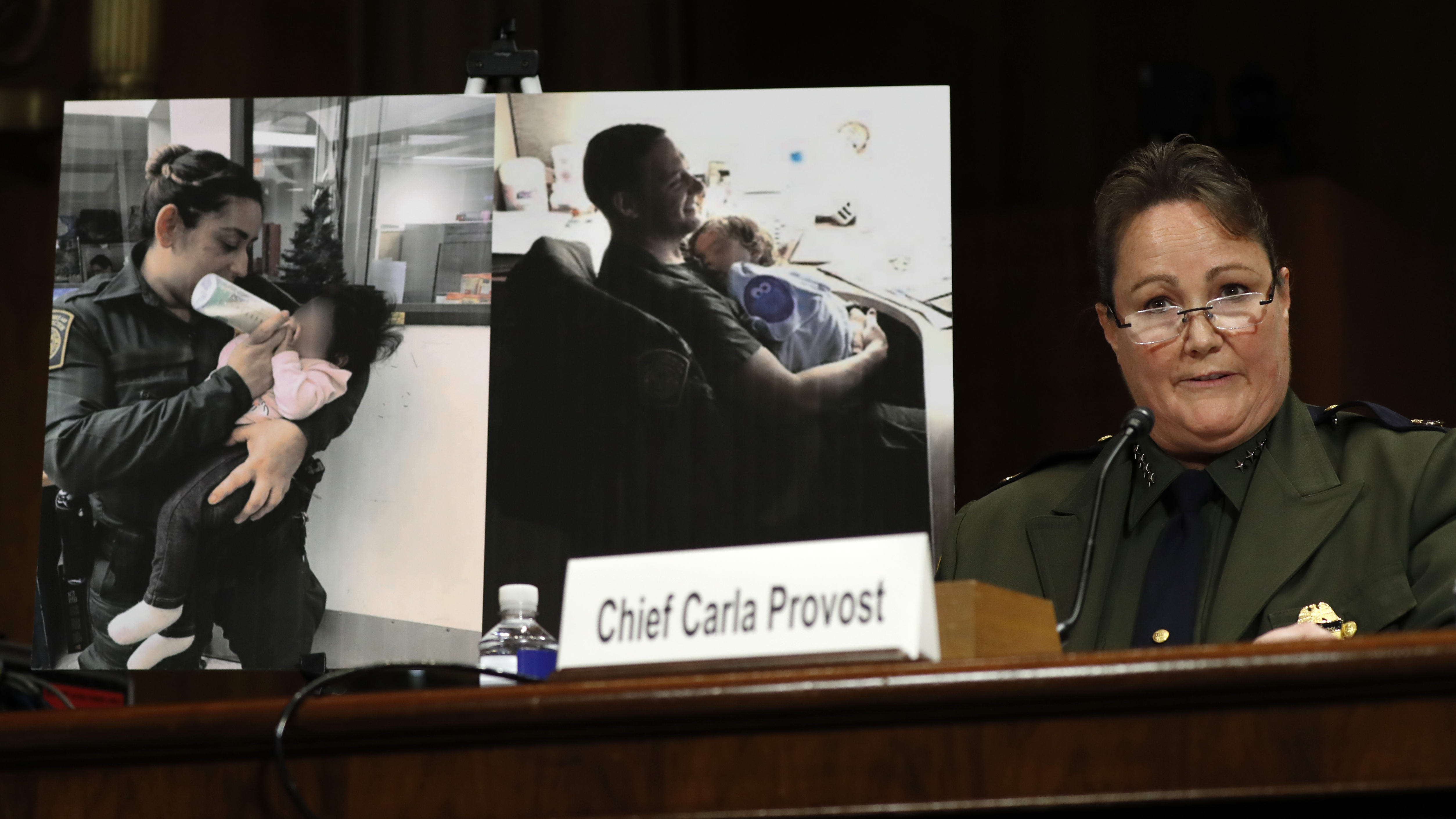 U.S. Border Patrol Chief Carla Provost testifies by a photo of agents with children during a Senate Judiciary Border Security and Immigration Subcommittee hearing.