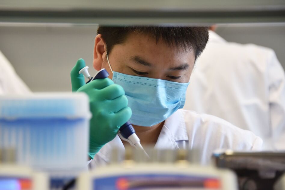 A technician works in a lab at GeseDNA Technology in Beijing. To counter China, the U.S. plans to impose new export restrictions on "emerging and foundational technology" that researchers say could affect the way they share genetic materials with international labs. (Greg Baker/AFP/Getty Images)