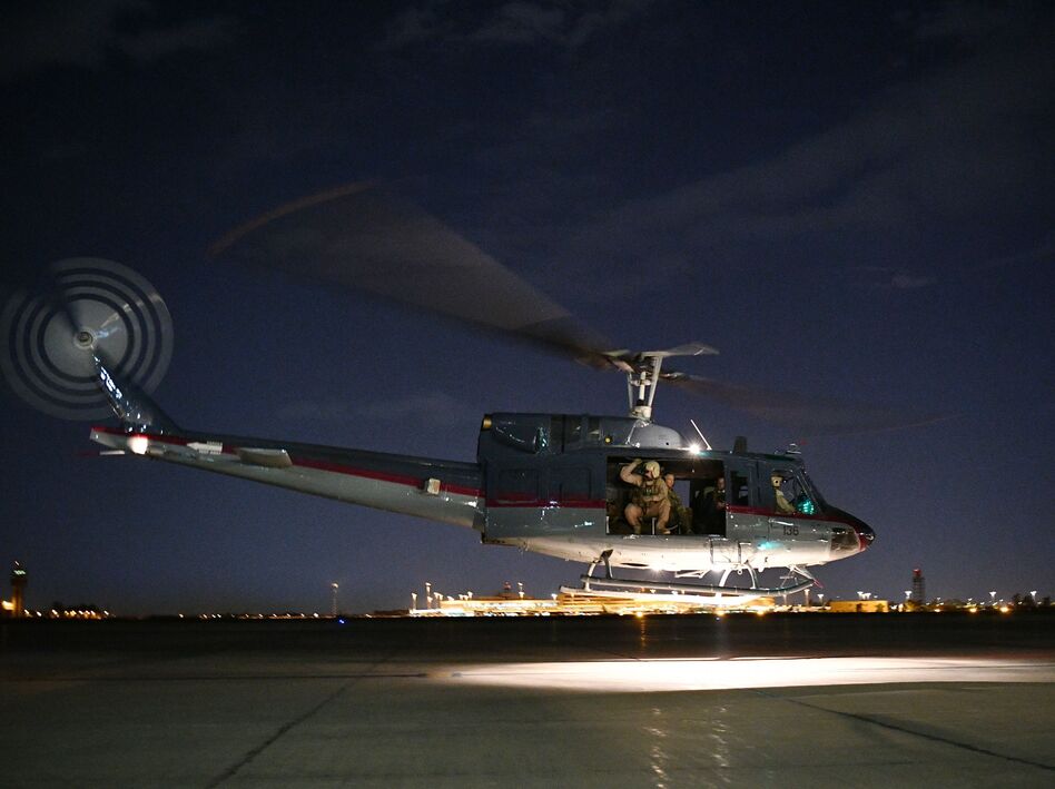 The State Department ordered "non-emergency" U.S. government employees out of Iraq on Wednesday. A helicopter carrying U.S. Secretary of State Mike Pompeo is seen taking off from Baghdad International Airport last week. (Mandel Ngan/AFP/Getty Images)