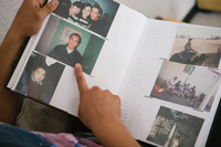 In his home in León, Olivas-Bejarano looks through an album with photographs of his time in the United States.