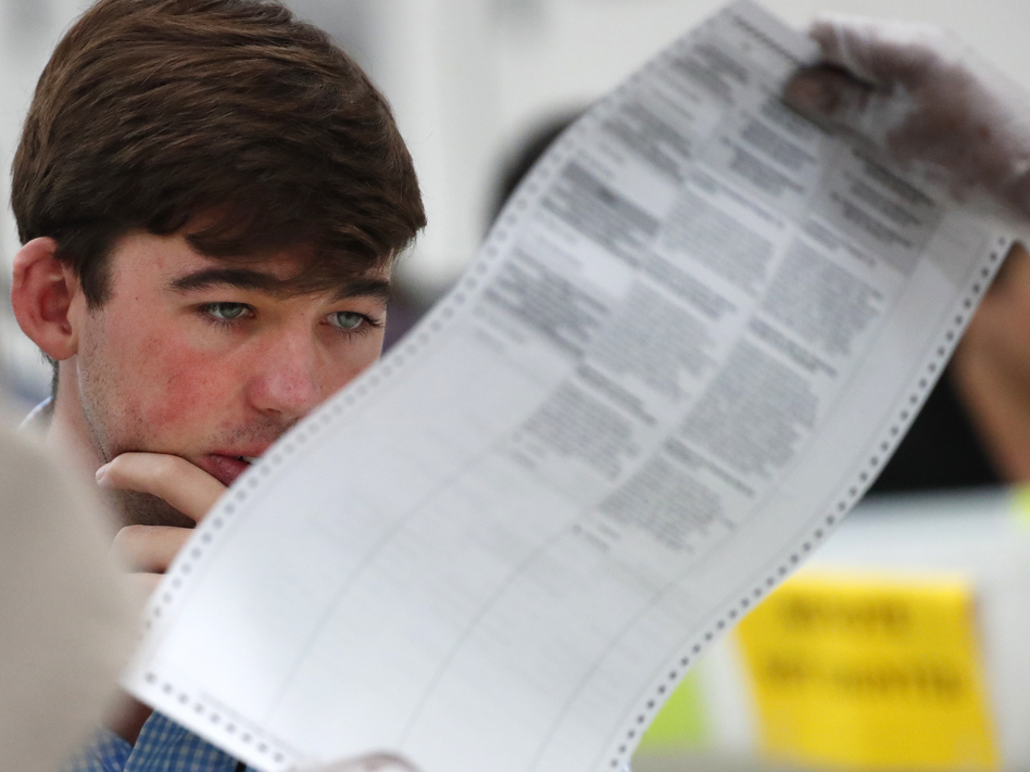 A Republican observer looks at a ballot during a hand recount last November in Broward County, Fla. Florida officials and lawmakers are still learning about cyberattacks there. (Wilfredo Lee/AP)