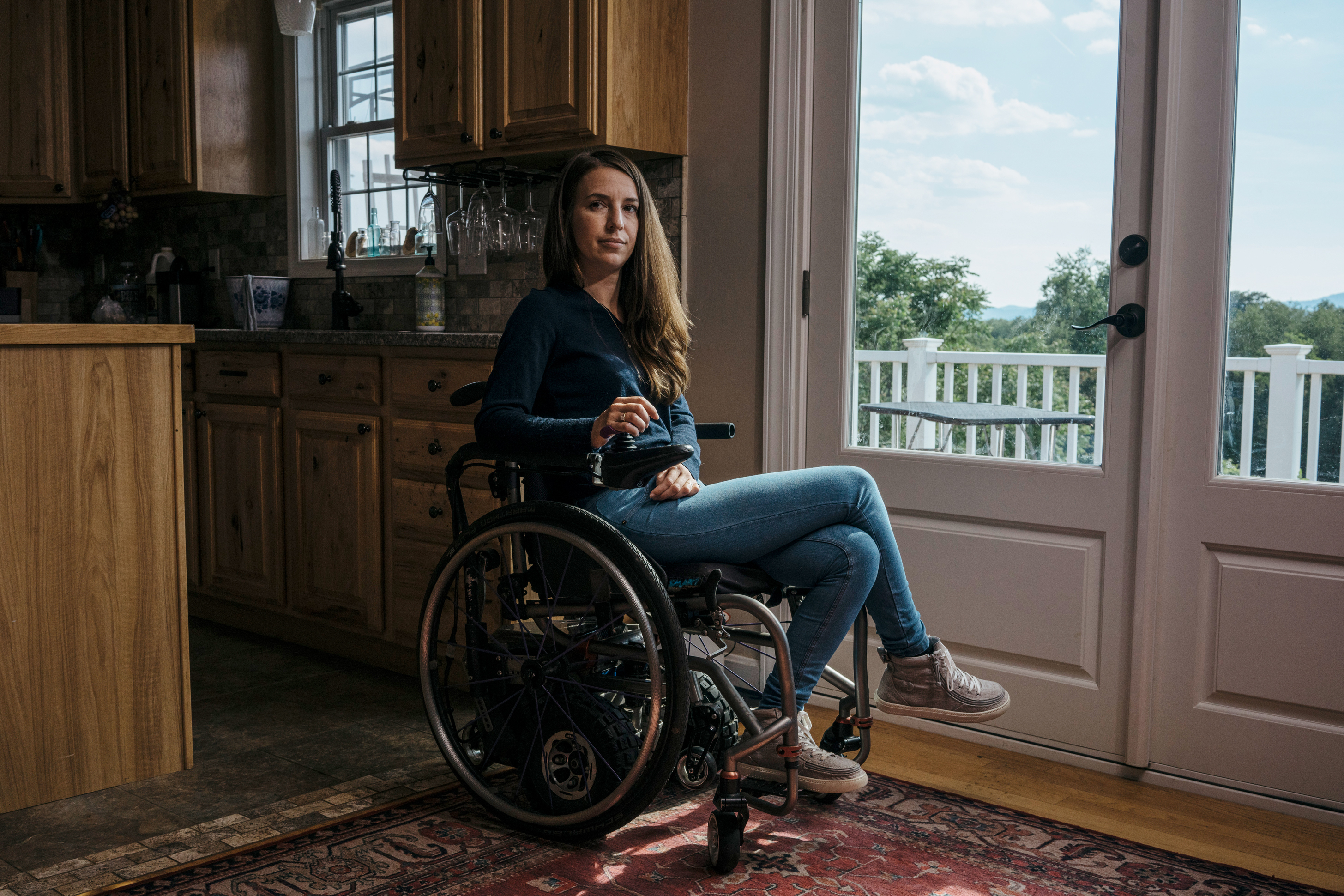 Dani Izzie at her home in rural Virginia. More than a decade ago, she slipped in the bathroom and suffered a spinal cord injury that has left her unable to walk. She works as a social media manager for Spinergy, a company that makes high-performance wheels for wheelchairs. (Greg Kahn for NPR)