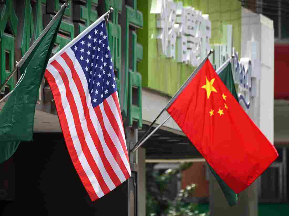 The US (L) and Chinese flags are displayed outside a hotel in Beijing on May 14, 2019.