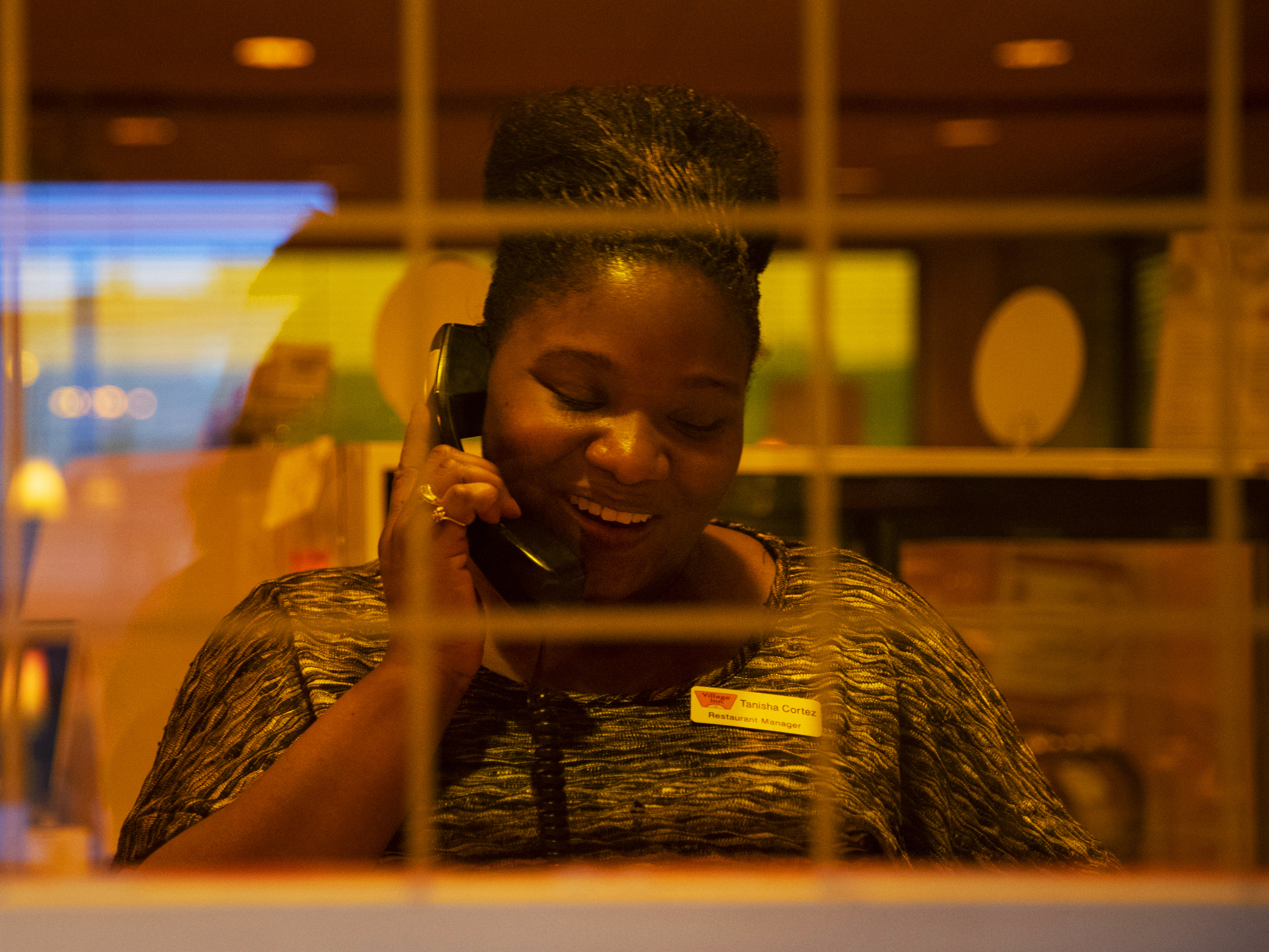 Cortez answers a call from a customer. She's earning $2,000 more a year than she made at her old job.