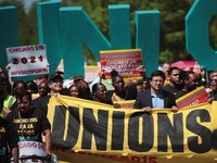 Demonstrators march to McDonald's corporate headquarters in Chicago on Thursday to demand $15-per-hour wages for fast food workers.