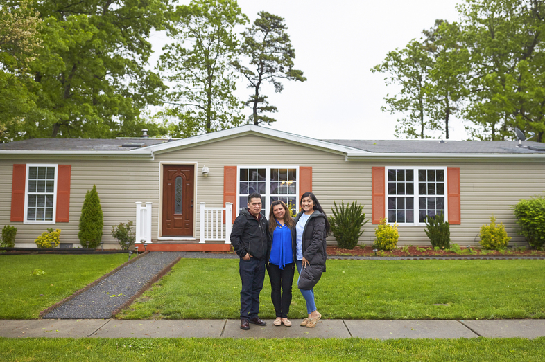 The Martinez family stands in front of their home in New Jersey. During a speech at her graduation, Alondra said to her parents: "Mamá, papá, lo logramos." Mom, dad, we made it. (Mohamed Sadek for NPR)