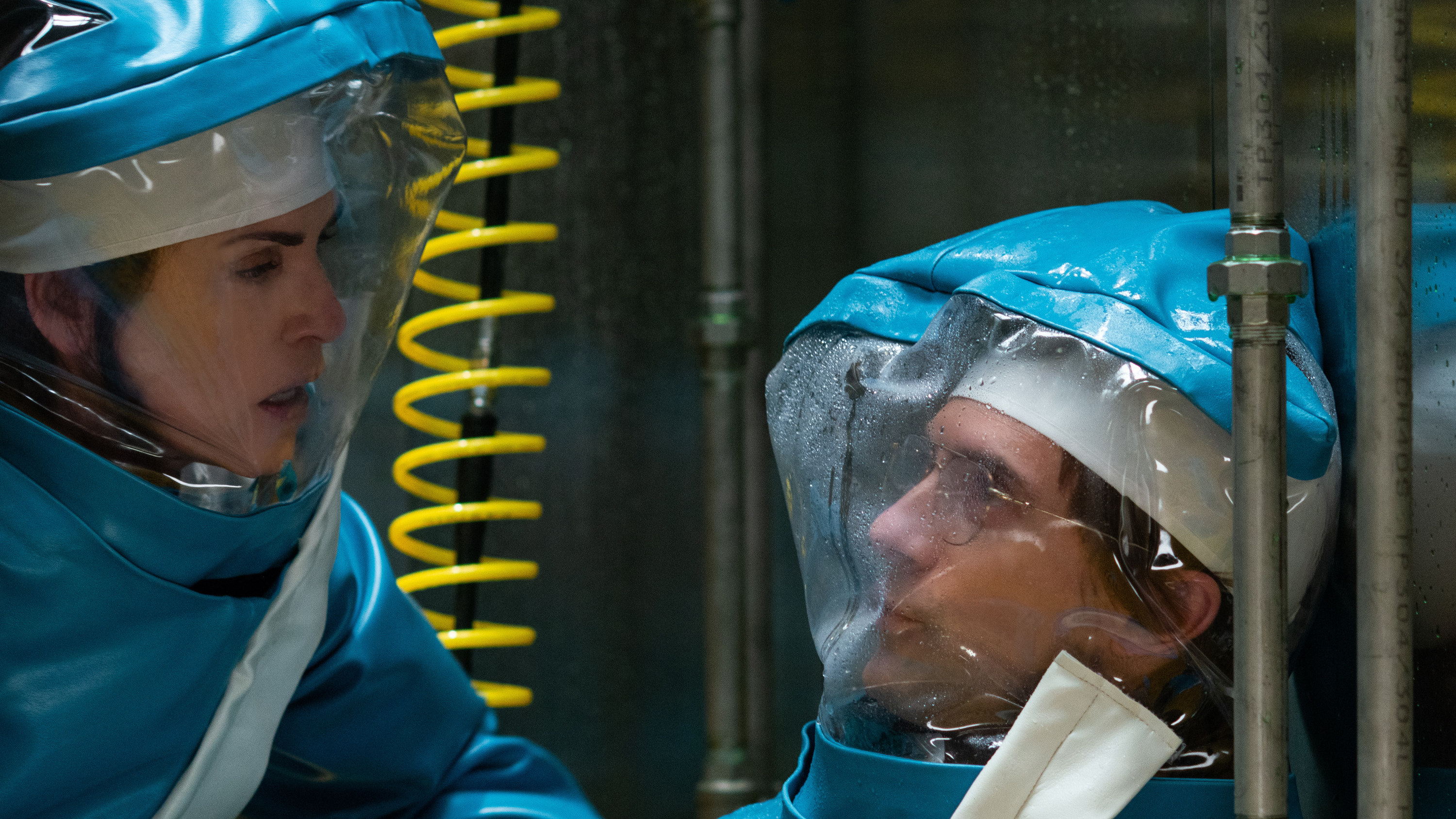 Dr. Nancy Jaax (Julianna Margulies) finds Dr. Peter Jahrling (Topher Grace) and shakes him awake to make sure he is OK during the Ebola investigation.