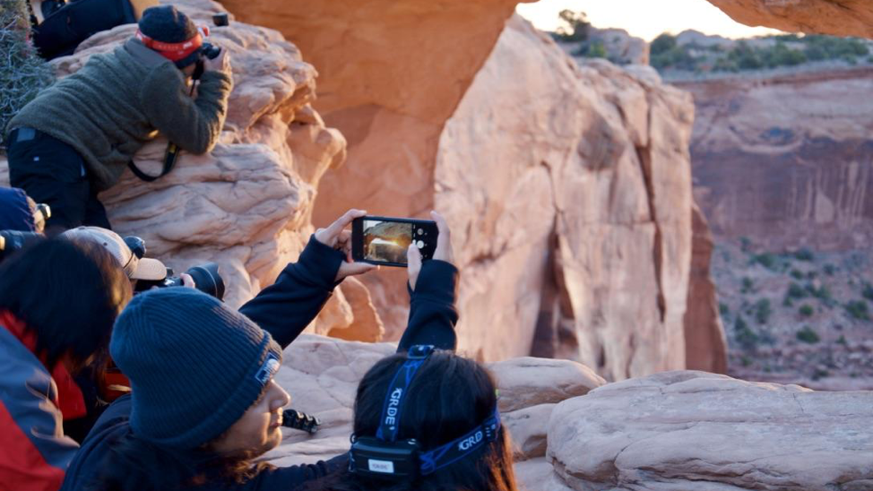 Around 50 tourists and photographers were huddled near Mesa Arch in Utah to catch a glimpse of the sunrise in early May. (KUER)