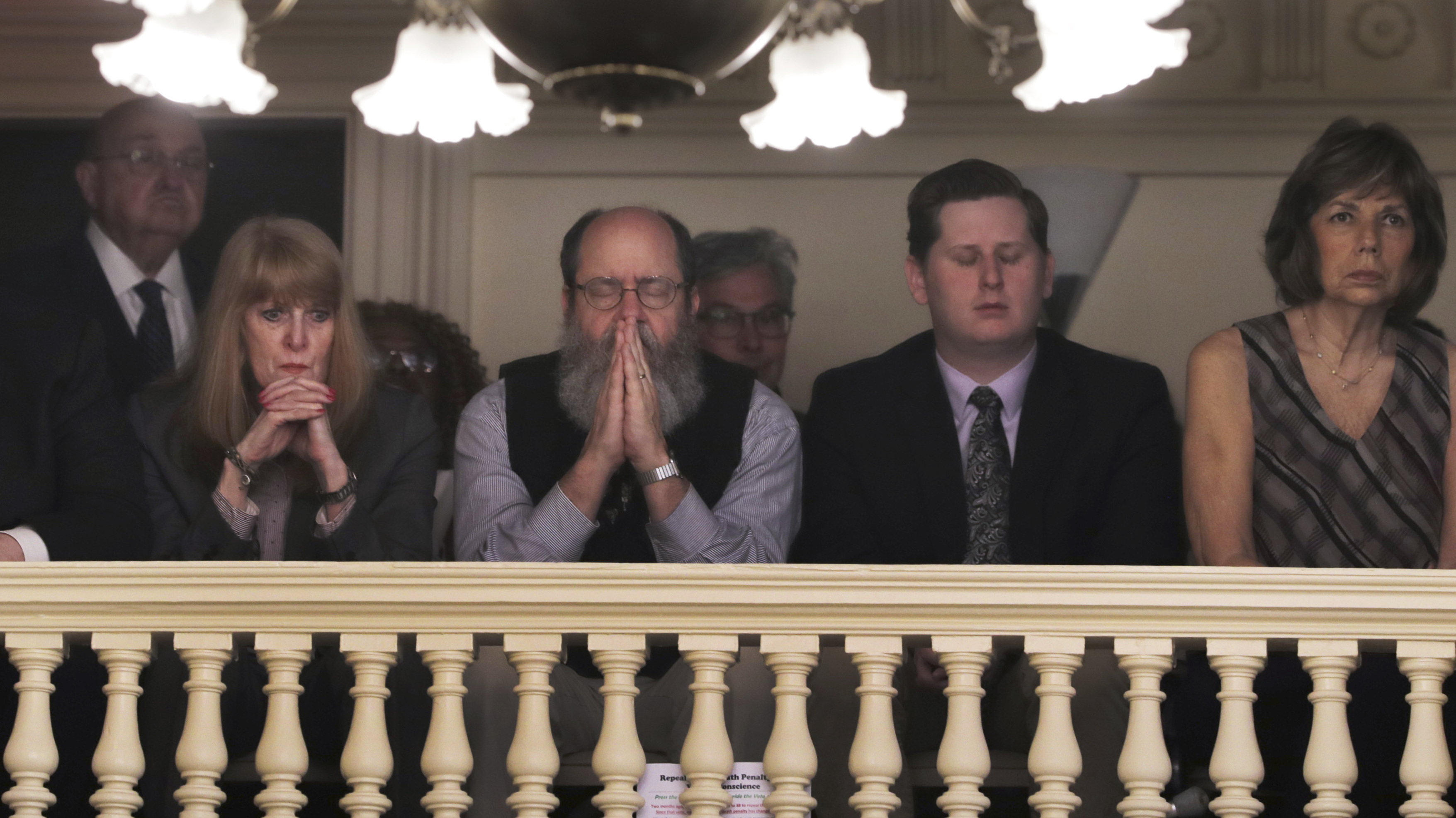 Rob Spencer prays as New Hampshire lawmakers debate prior to a death penalty vote at the State House in Concord, N.H., on Thursday. The legislature abolished capital punishment by overriding a veto by Gov. Chris Sununu.