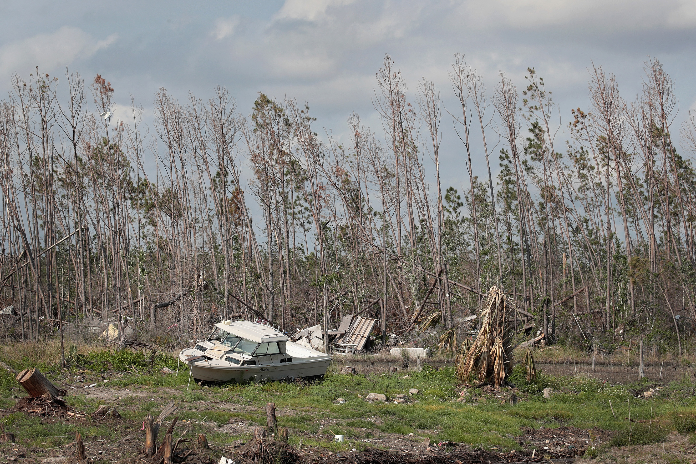 A boat moved by Hurricane Michael rests near a canal in May in Mexico Beach, Fla. Seven months after the hurricane made landfall, the town is still littered with heavily damaged or destroyed homes and businesses. (Scott Olson/Getty Images)