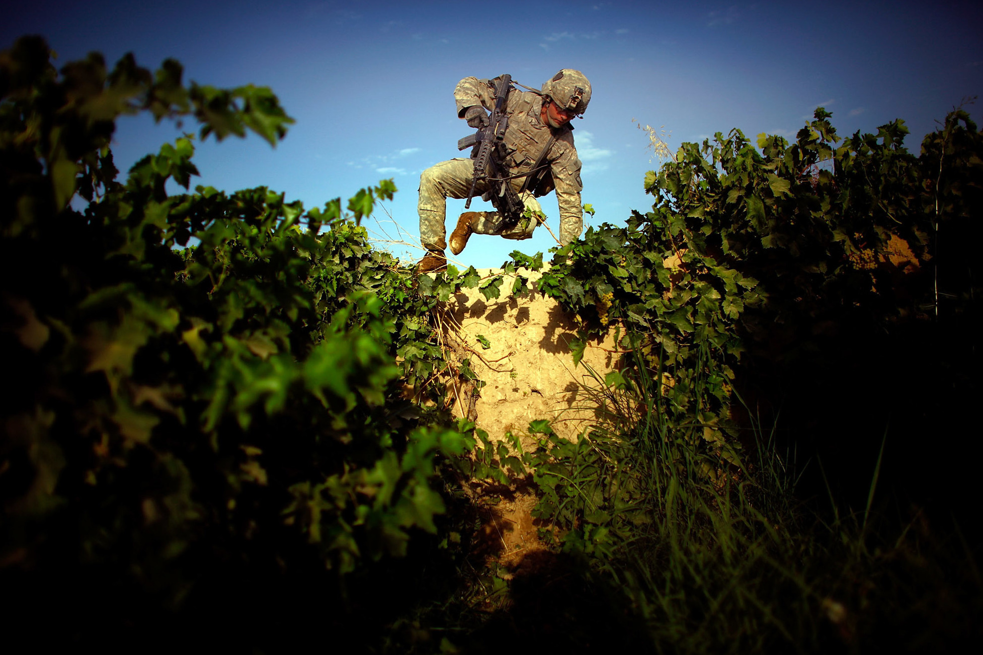 An Artist And A Warrior: Colleague Remembers Fallen NPR Photographer David Gilkey 1 Pfc. James Turner with Bravo Company, 101st Airborne Division jumps over an 8-foot-high mud wall while navigating a grape field and trying to avoid walking on a heavily traveled path in the Pashmul District of Kandahar province in southern Afghanistan.
